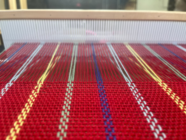 Close up of thread on loom.